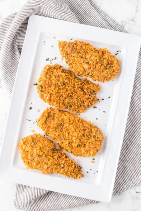 Chicken breasts coated in a corn flake mixture.