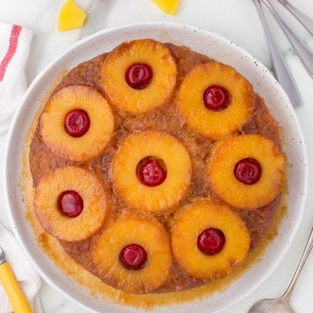 Cherries, pineapple on a yellow cake.