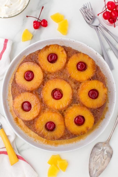 Cherries, pineapple on a yellow cake.