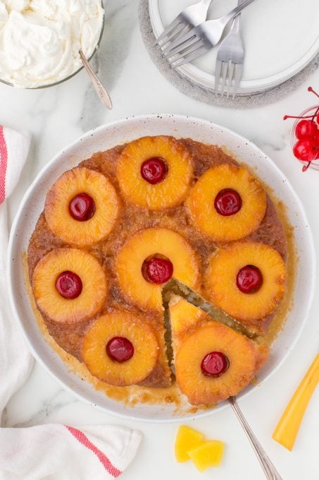 Brown sugar topping on cake with pineapple and cherries.