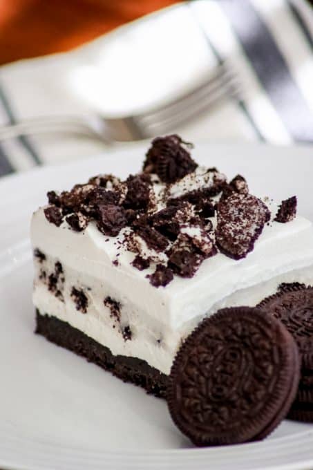 Oreo Pudding Dream Bars or Cookies and Cream Bars on a plate with some Oreo cookies.