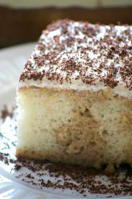 This Easy Tiramisu Poke Cake is a white cake mix drizzled with a sweetened coffee syrup, and topped with a whipped mascarpone vanilla frosting. It's a simple recipe to put together without the liqueur and uses Fair Trade ingredients.