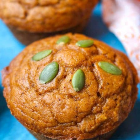 A Dairy-Free Pumpkin Muffin topped with pepitas.