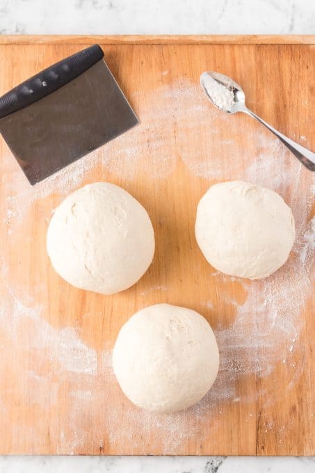 Pizza dough made into three balls.