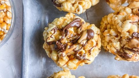 Peanut Butter Popcorn Balls drizzled with chocolate and PB2 Organic Powdered Peanut Butter.