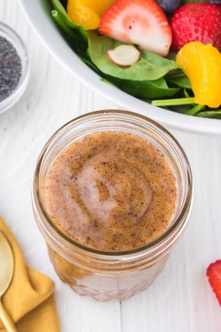 Dressing for salad made with poppy seeds in a jar.