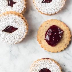 A bunch of Christmas cookies with raspberry jam.