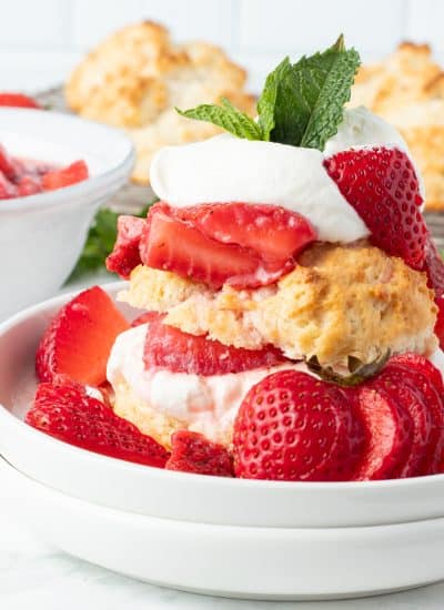 Macerated strawberries, a lightly sweetened biscuit, and whipped cream.