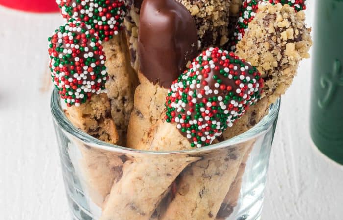 A dish full of decorated stick cookies.