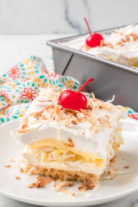 A no bake layered cheesecake dessert with coconut and pineapple.