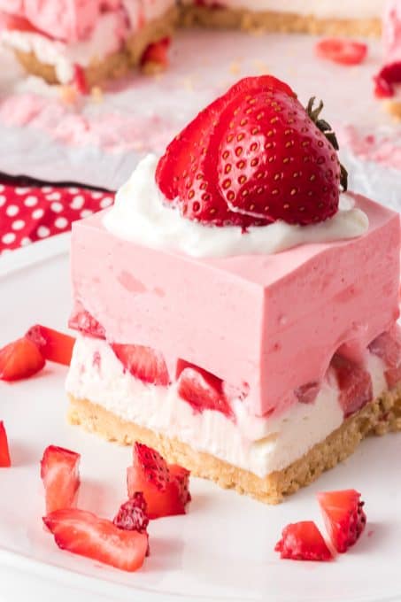 Golden Oreo crust, creamy cheesecake, and a strawberry gelatin layer in this no bake dessert.