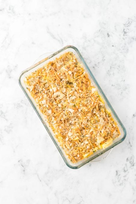 A side dish casserole of yellow squash ready for the oven.