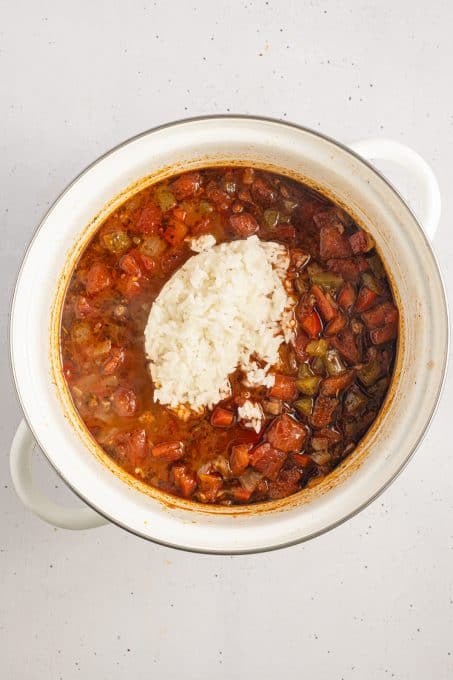 Rice added to soup with chopped peppers, onions and ground beef.