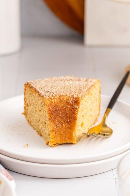 A piece of donut cake made with apple cider, applesauce and cinnamon sugar.