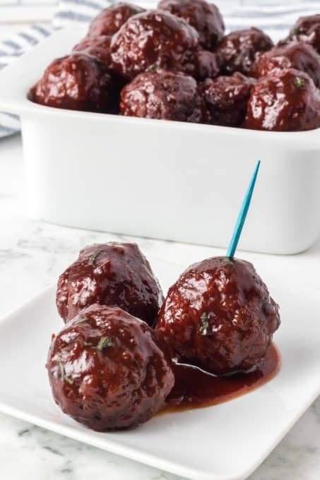 Meatballs marinated in grape jelly and chili sauce.