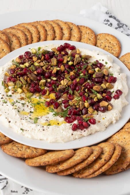 Feta cheese that has been whipped served with arils and pistachios.