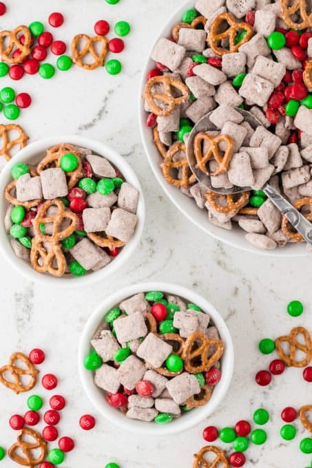 Bowls of holiday Chex Muddy Buddies, perfect for snacking or holiday movie night.