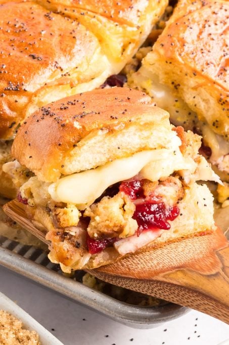 Cranberry sauce, stuffing, cheese, and turkey on a Hawaiian roll.