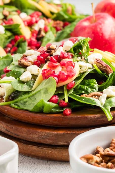 Pomegranate arils top a spinach salad.