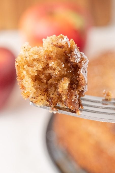 A bite of a cake made with apples.