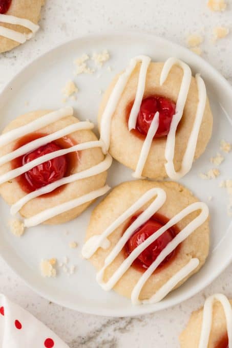 A vanilla glaze on Cherry Thumbprints.