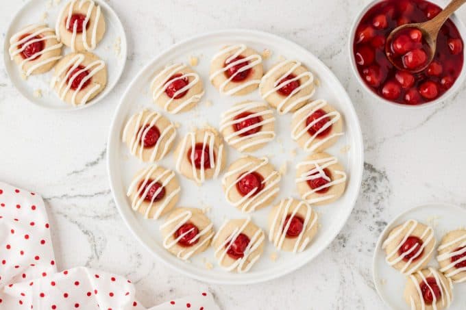 Cookies with thumbprints, cherries and a glaze.