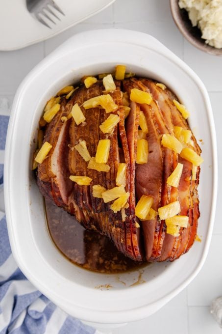 A slow cooker spiral ham with brown sugar and pineapple.