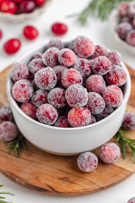 A bowl of cranberries coated in a simple syrup and rolled in sugar.