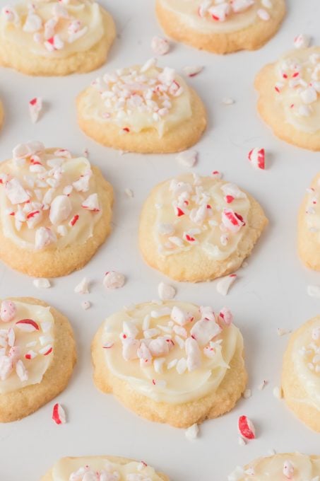 Crushed candy canes on top of cream cheese frosted meltaway cookies.