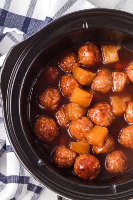 Meatballs and pineapple in a sweet and sour sauce.