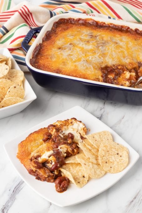 A chili dip with two kinds of cheeses.