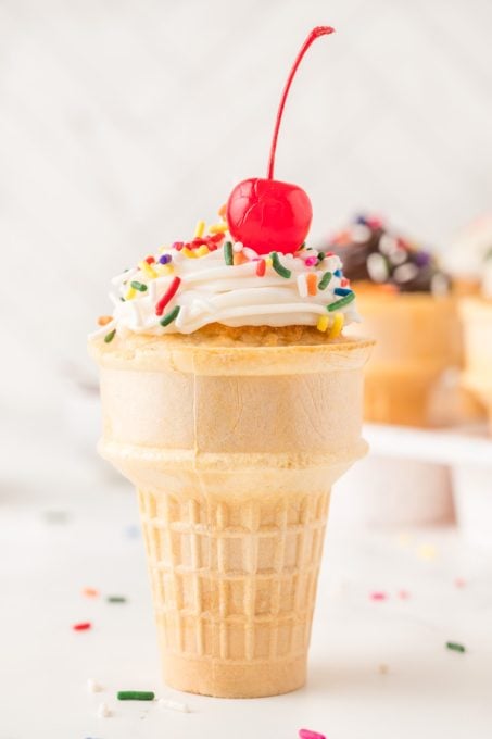 An ice cream cone with a cupcake inside.