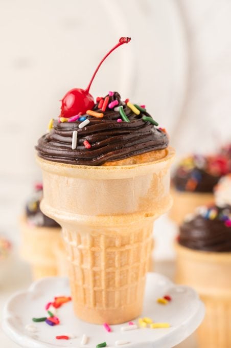 Chocolate frosting on a cupcake ice cream cone.